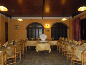 a large banquet hall with tables and chairs in it at L'Ostu del Povr-Om in Pinasca 