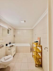 a bathroom with a tub and a toilet and a sink at OLD TOWN Palatul Agoston Galgon in Timişoara +67 photos