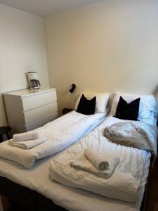 a bedroom with two beds with towels on them at Oppheim Resort - Pool, Sauna & Lake! in Vossevangen