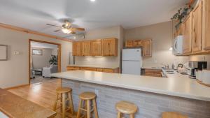a kitchen with wooden cabinets and a counter top at 2BR Condo by Lake w Deck, Jetted Tub - Raindrop in Pepin
