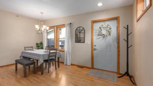 a dining room with a table and chairs and a door at 3BR Condo Near Lake Pepin w 2 Kitchens - Lantern Condos in Pepin +30 photos