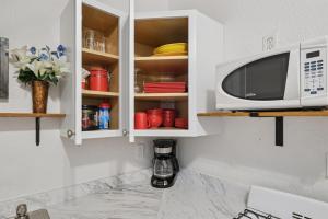 a microwave oven sitting inside of a kitchen cabinets at 1BR Apartment Across from Como Lake - Bayberry in Saint Paul +15 photos