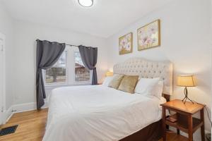 a bedroom with a large white bed and a window at 1BR Apartment Across from Como Lake - Bayberry in Saint Paul