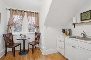 a kitchen with a table and chairs and a sink at 1BR Apartment Across from Como Lake - Bayberry in Saint Paul