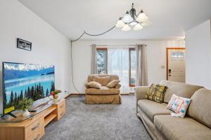 a living room with a couch and a tv at CBI Haven 1 & 2 in Milwaukee