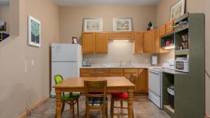 a kitchen with a table and chairs and a refrigerator at Three Connected Quirky Condos By Beach! - Twilight Condo in Pepin
