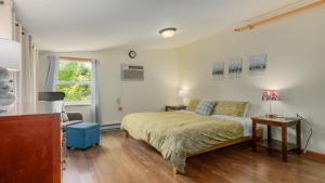 a bedroom with a bed and a chair and a window at Three Connected Quirky Condos By Beach! - Twilight Condo in Pepin