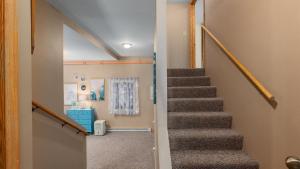 a staircase in a house with a stair case at Three Connected Quirky Condos By Beach! - Twilight Condo in Pepin