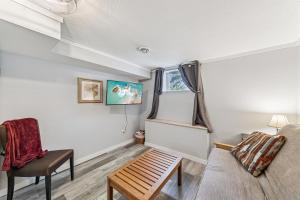 a living room with a couch and a chair at Cozy 2BR Garden Apartment Near Lake Pepin - Daisy in Pepin