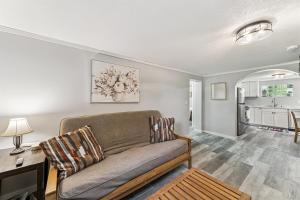 a living room with a couch and a kitchen at Cozy 2BR Garden Apartment Near Lake Pepin - Daisy in Pepin