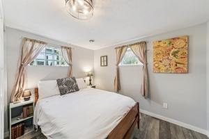 a bedroom with a bed and two windows at Cozy 2BR Garden Apartment Near Lake Pepin - Daisy in Pepin +15 photos