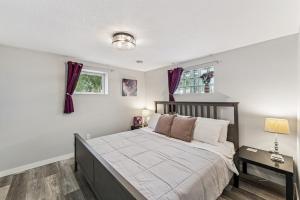 a bedroom with a bed and a window at Cozy 2BR Garden Apartment Near Lake Pepin - Daisy in Pepin
