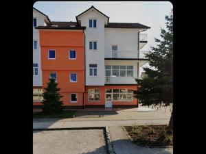 a large apartment building with an orange at Apartman Ivan in Tomislavgrad