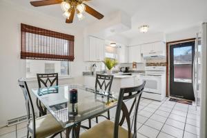 a kitchen with a glass dining table and chairs at CBI Haven 1 & 2 in Milwaukee