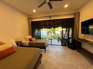 a living room with a couch and a tv at Nomads Kite House in El Cuyo