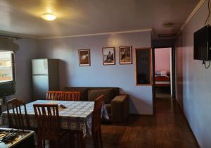 a living room with a table and a couch at cabañas Dany in Concón