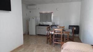 a kitchen with a table and chairs and a refrigerator at Tunquelen II in Colorado River