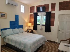 a bedroom with a blue bed and a window at Luxury Posada inn in Los Amates +23 photos