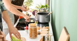 a group of people preparing food in a kitchen at Calm hostel in Antigua Guatemala
