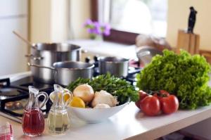 a kitchen counter with a bowl of vegetables and tomatoes at Calm hostel in Antigua Guatemala +18 photos