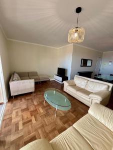 a living room with a couch and a table at Santos Living Rentals in Funchal