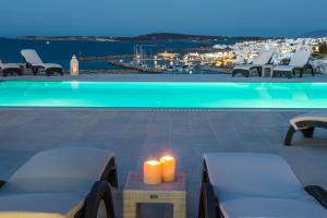 a swimming pool with a view of a city at night at Villa Irini in Naousa