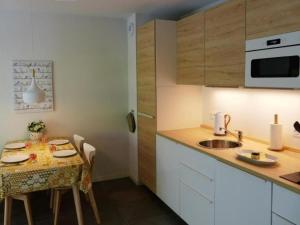 a small kitchen with a table and a sink at Apartment by Interhome in Cambo-les-Bains