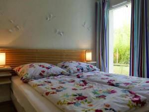 a bedroom with two beds and a window at Apartment by Interhome in Cambo-les-Bains +10 photos