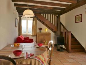 a dining room with a table and a staircase at by Interhome in Louhossoa