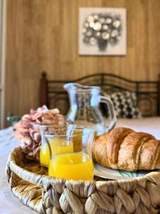 a tray of orange juice and bread on a table at Ocean Hill House by Rentery Madeira in Santa Cruz