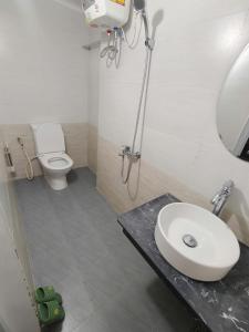 a bathroom with a sink and a toilet and a mirror at MOJA HOUSE l Homestay Huế in Thôn Dương Xuân Hạ +19 photos