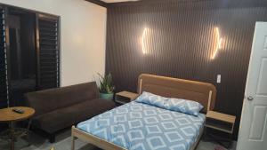 a living room with a bed and a couch at Villa 820 in Pacific Harbour +36 photos