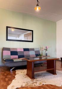 a living room with a couch and a table at Ocean Hill House by Rentery Madeira in Santa Cruz +30 photos