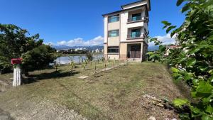 a house with a garden in front of a building at 荷民宿 HO Homestay in Yuanshan
