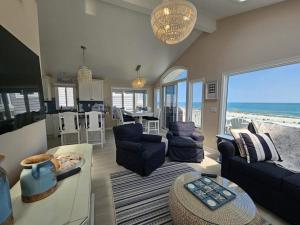 a living room with a view of the ocean at Second Floor Oceanfront Unit in Brant Beach