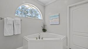 a white bathroom with a sink and a window at 30A Cottage Near the Beach with Golf Cart in Inlet Beach +31 photos
