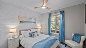 a bedroom with a bed and a chair and a window at 30A Cottage Near the Beach with Golf Cart in Inlet Beach