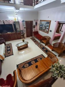 a living room with a couch and a table at Cozy Nest in Pūvār