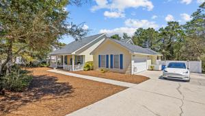 a house with a car parked in front of it at 30A Cottage Near the Beach with Golf Cart in Inlet Beach