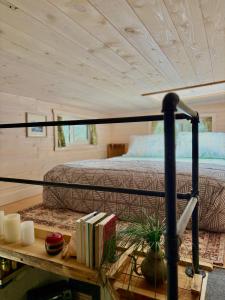 a bedroom with a bed and a table with books at Forest Nook in Queens Bay +56 photos
