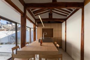 a kitchen and dining room with a wooden table and chairs at THE CHAE Premium Hanok Stay in Seoul