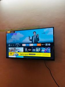 a flat screen tv hanging on a wall at Sujata Homestay in Queula +4 photos