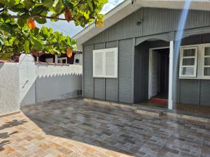a house with a garage and a driveway at Casa Chalé Ilha Comprida in Ilha Comprida