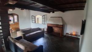 a living room with a couch and a fireplace at Casa do Sargento in Saquarema