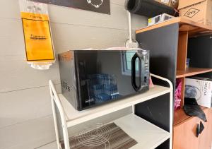 a microwave sitting on top of a chair at MBB House in Thalang