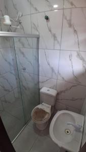 a bathroom with a toilet and a shower at Casa do Sargento in Saquarema +10 photos