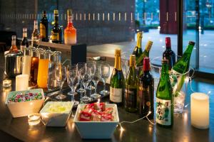 a table topped with bottles of wine and glasses at Villa Fontaine Grand Tokyo Tamachi in Tokyo