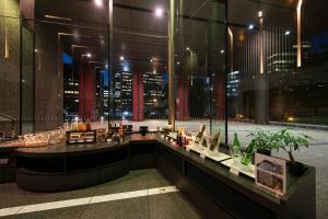 a restaurant with a view of a city at night at Villa Fontaine Grand Tokyo Tamachi in Tokyo +35 photos