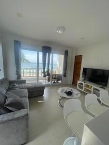 a living room with a couch and a television at Tyne Haven in San Juan