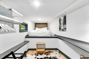 a bedroom with a bed and a chair at Montlake Studio in Spite House in Seattle